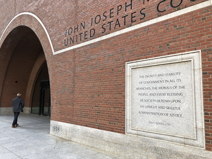 caption: Etchings on the federal courthouse in Boston acclaim a well-administered justice system, but many working in the building say that's getting harder, given the ongoing federal shutdown.