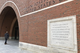 caption: Etchings on the federal courthouse in Boston acclaim a well-administered justice system, but many working in the building say that's getting harder, given the ongoing federal shutdown.