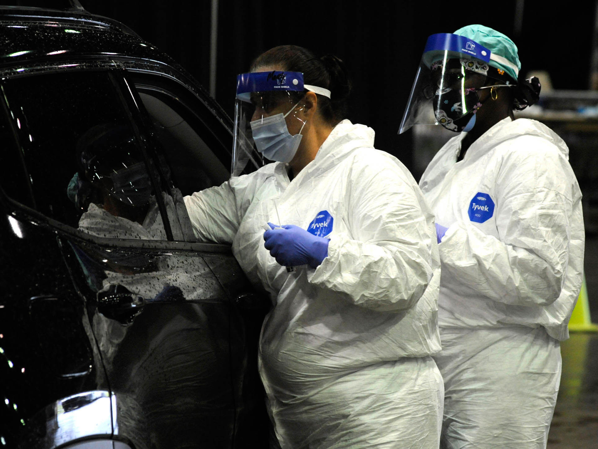 caption: A medical worker tests a person for COVID-19 last month in Mobile, Ala. A surge of coronavirus cases in the state has stretched hospital ICUs to capacity, making it difficult for patients with other conditions to find ICU beds.