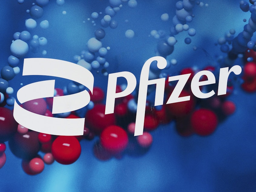 caption: The Pfizer logo is displayed at the company's headquarters in New York last year.