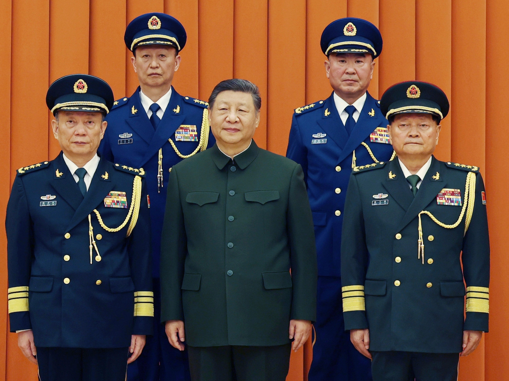 caption: In this photo released by Xinhua News Agency, Chinese President Xi Jinping, also chairman of the Central Military Commission (CMC), front row second from left, poses with other military officers after promoting to generals, back row, from left, Yang Zhibin of the Eastern Theater Command and Han Shengyan commander of Central Theater Command in Beijing on Monday, Dec. 22, 2025.