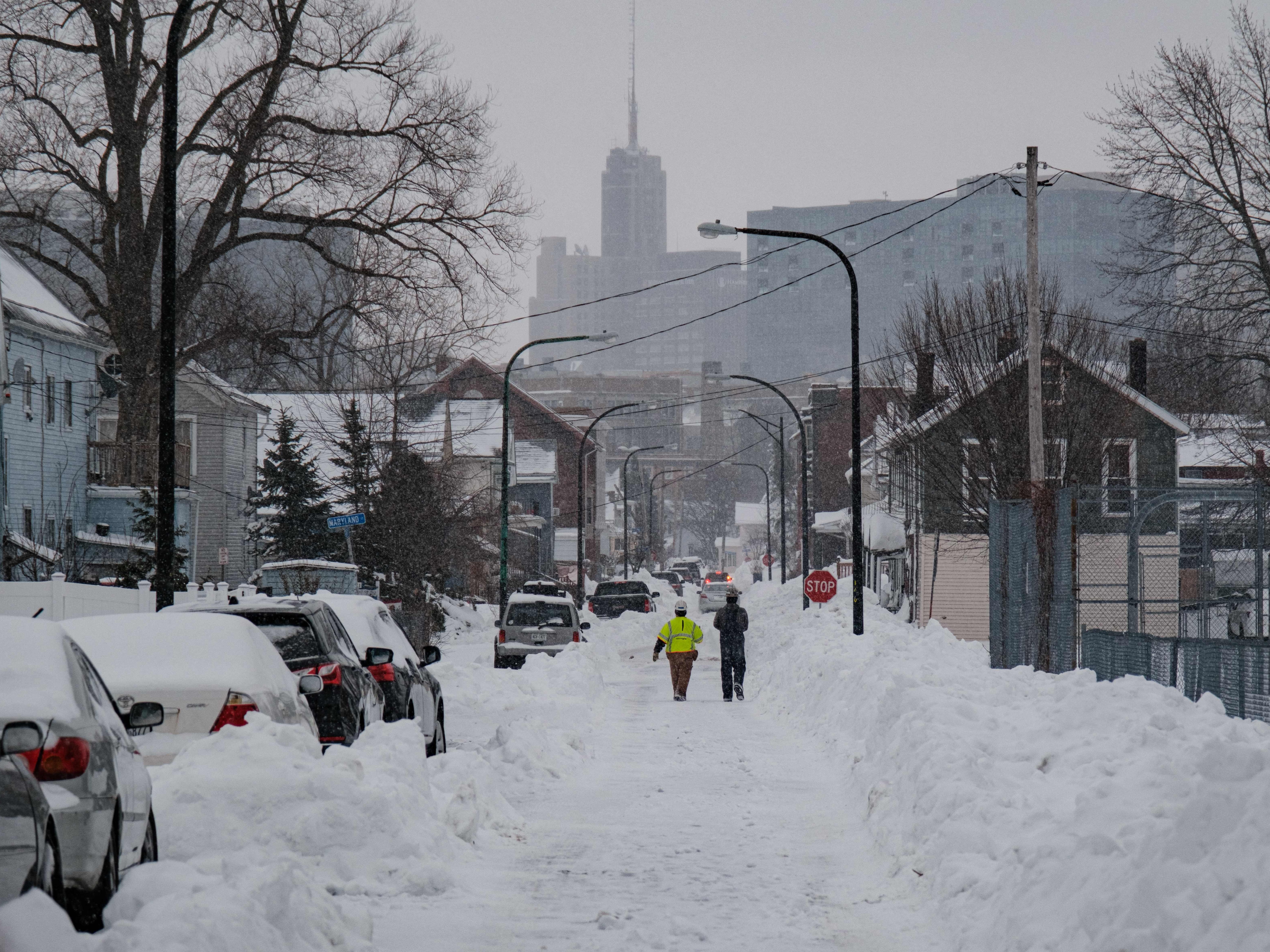 caption: National Grid workers respond to a downed utility pole in Buffalo, N.Y., on Tuesday. The monster storm that killed dozens in the United States over the Christmas weekend continued to inflict misery on New York state and air travelers nationwide.