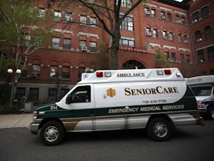 caption: An ambulance pulls up outside a nursing home in Brooklyn, N.Y. Two senators have called for an investigation of five states, including New York, which ordered nursing homes to admit patients who tested positive for COVID-19.