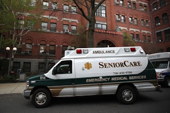 caption: An ambulance pulls up outside a nursing home in Brooklyn, N.Y. Two senators have called for an investigation of five states, including New York, which ordered nursing homes to admit patients who tested positive for COVID-19.