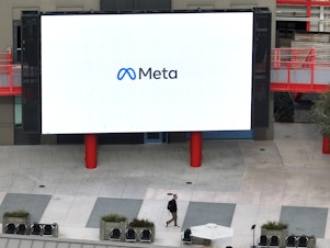 caption: A large video monitor on the campus of Meta, Facebook's parent company, in Menlo Park, Calif. in February. New research about Facebook shows its impact on political polarization.