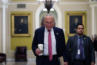 caption: Senate Majority Leader Charles Schumer of New York walks to his office at the U.S. Capitol on Thursday.
