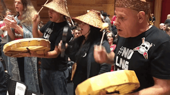 caption: Fossil-fuel protesters sing before Gov. Jay Inslee's town hall on climate change