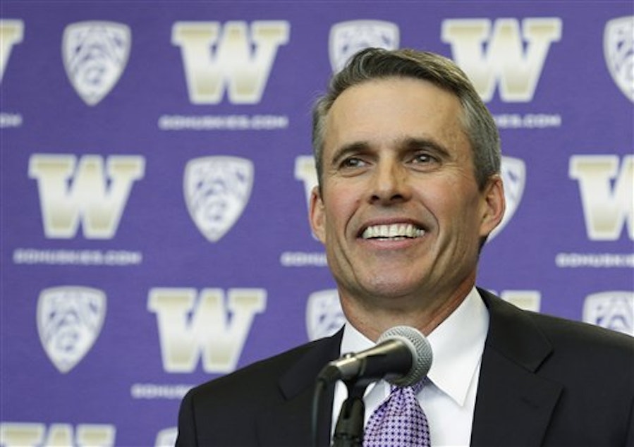 caption: Chris Petersen smiles as he takes questions from reporters after being introduced as the new head football coach at the University of Washington, Monday, Dec. 9, 2013, in Seattle.