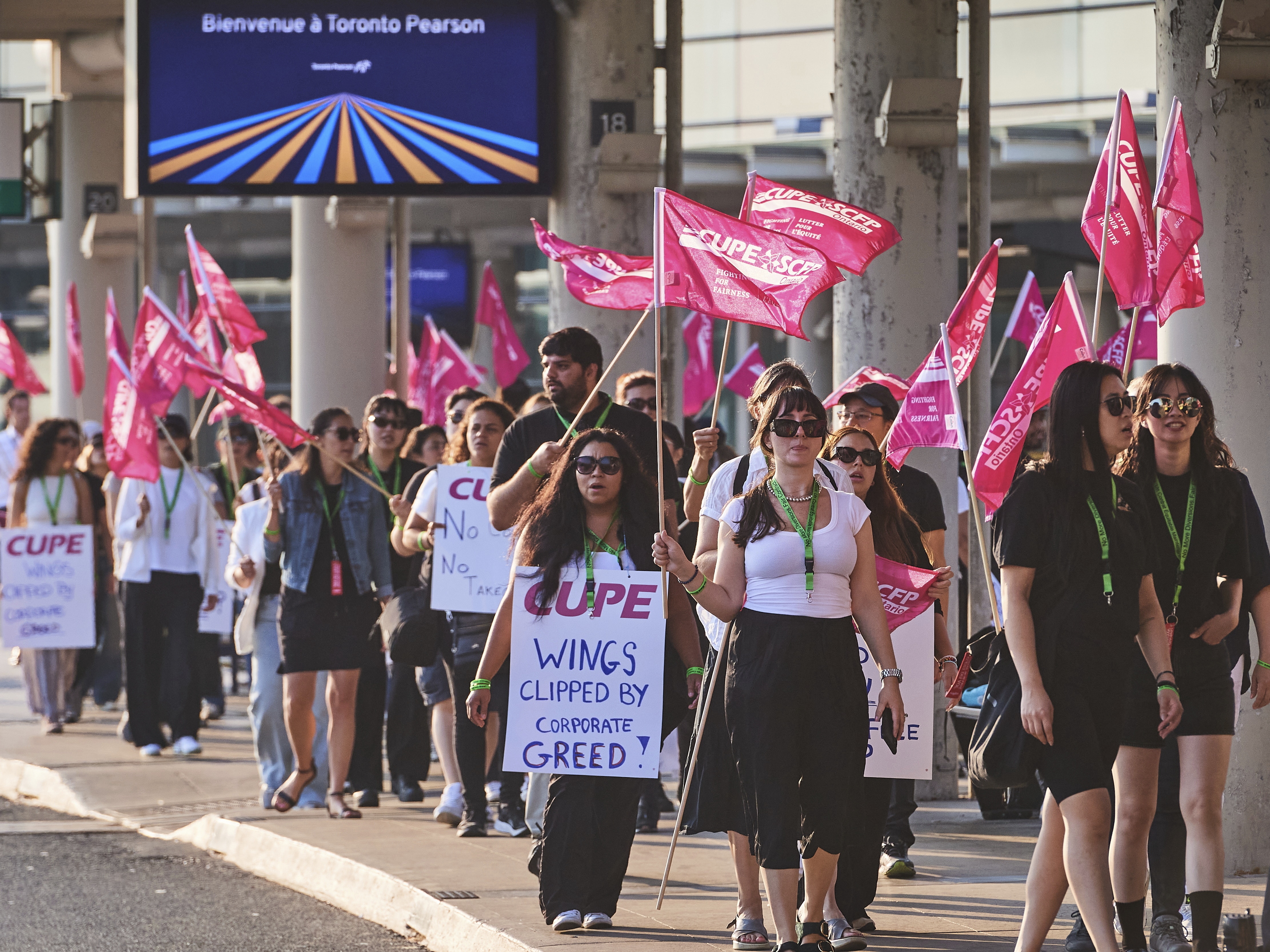 caption: Air Canada flight attendants picket at Pearson International Airport in Toronto on Saturday.