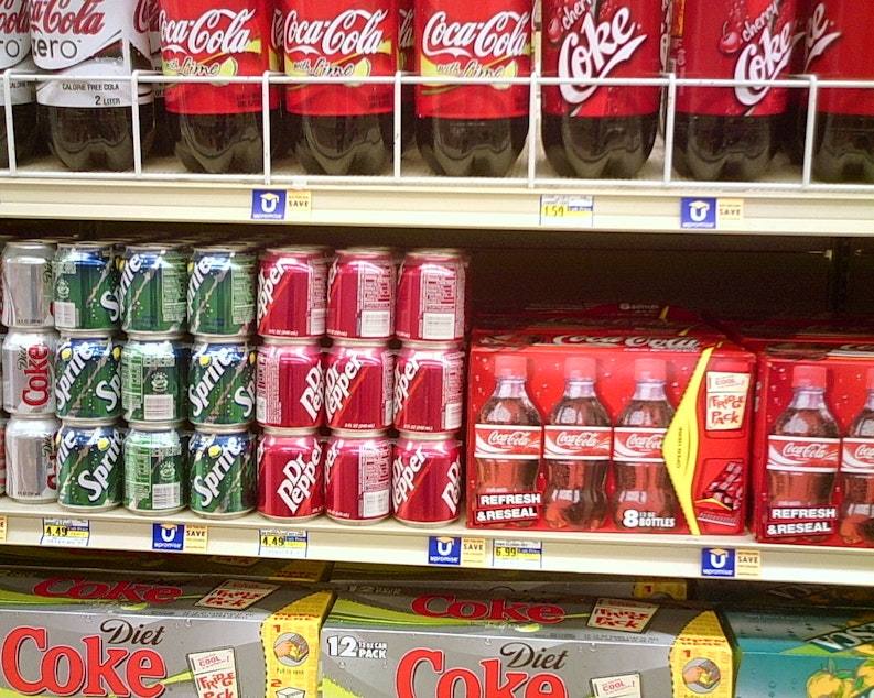 caption: Soda shelves at grocery store