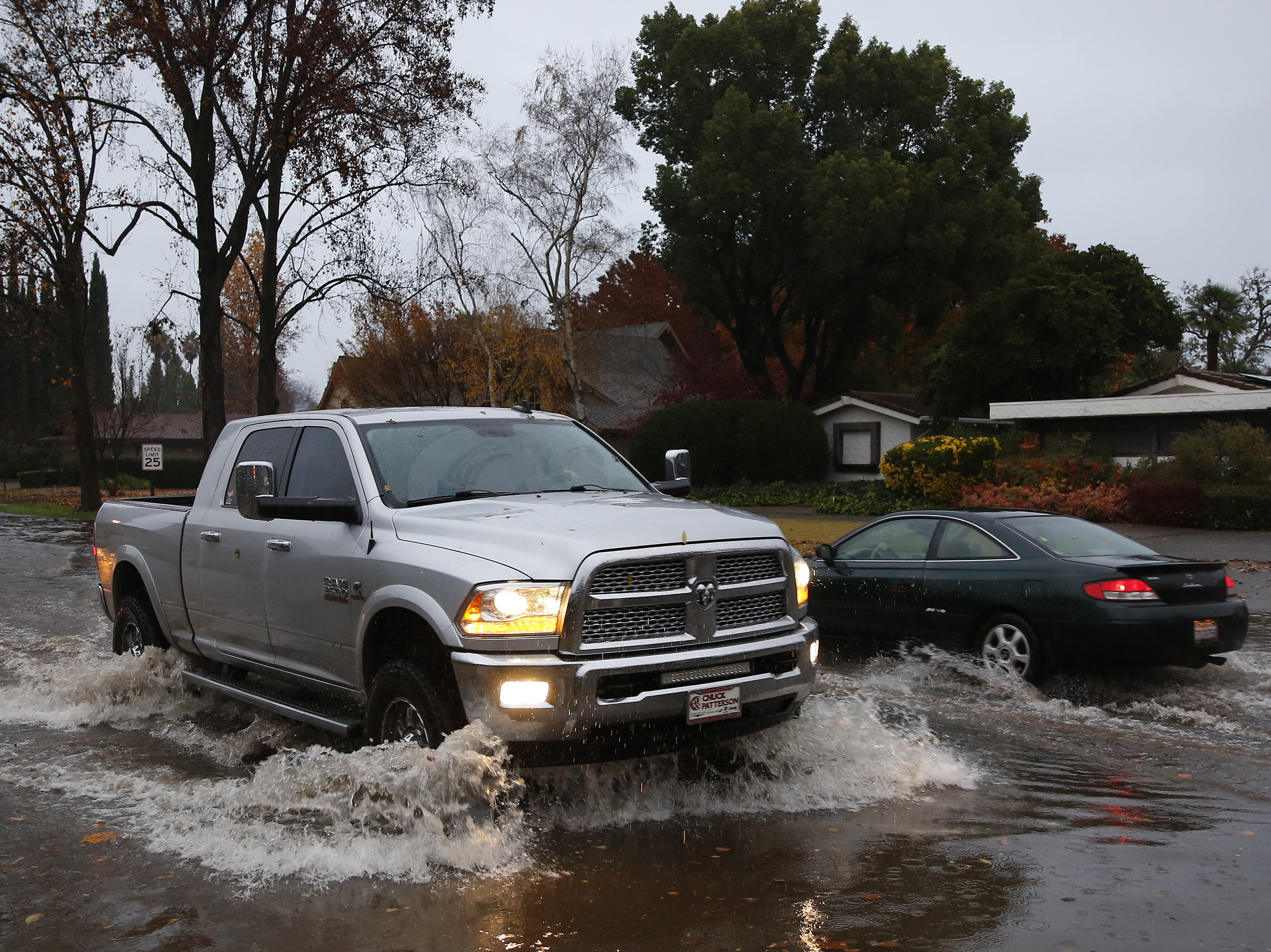 caption: Vehicles pass each other on a flooded street in Chico, Calif. Flash flooding hit a wildfire-scarred area of Northern California on Thursday, forcing officials to deploy swift water rescue teams to save people stuck in vehicles and rescue them from homes after a downpour near the Paradise area.