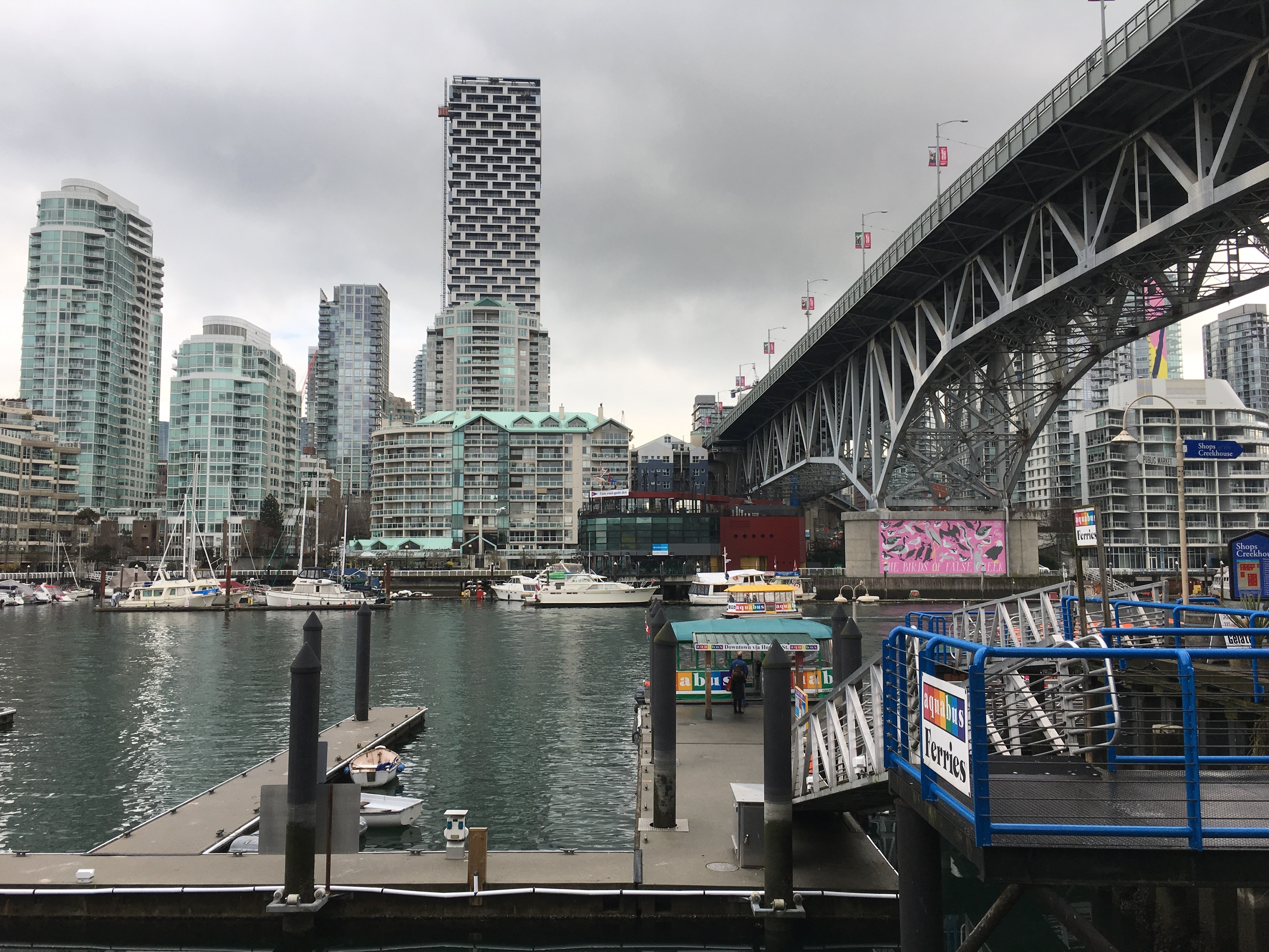caption: The Granville Street Bridge leads to downtown Vancouver, whose skyline of gleaming apartment towers hugging the waterfront is reminiscent of Hong Kong.