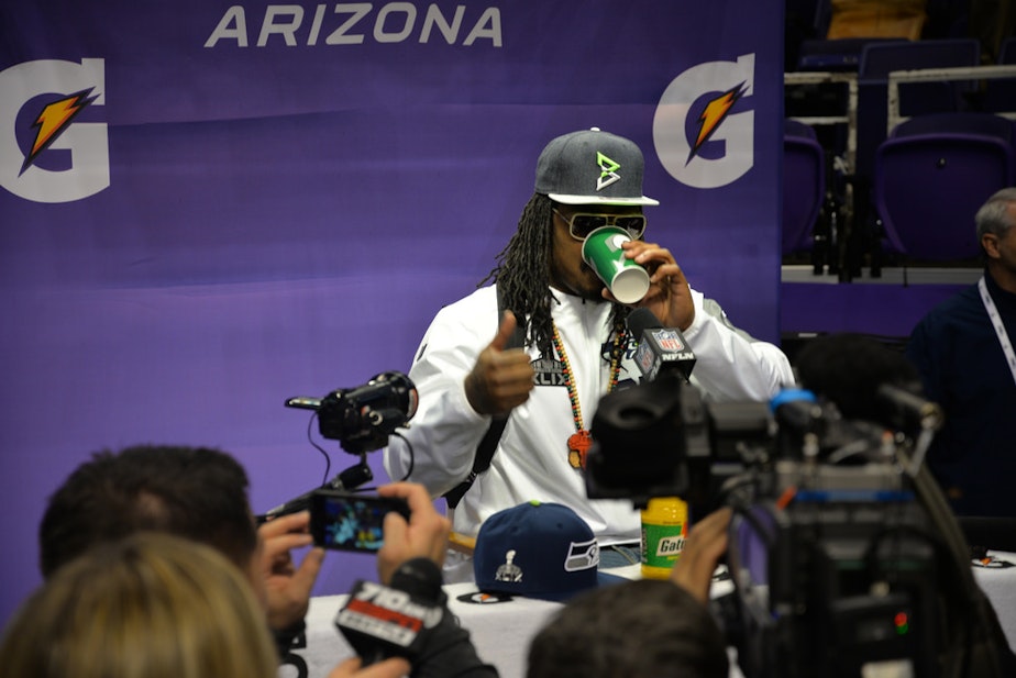 caption:  Running back Marshawn Lynch talks with reporters on Jan. 27, 2015.