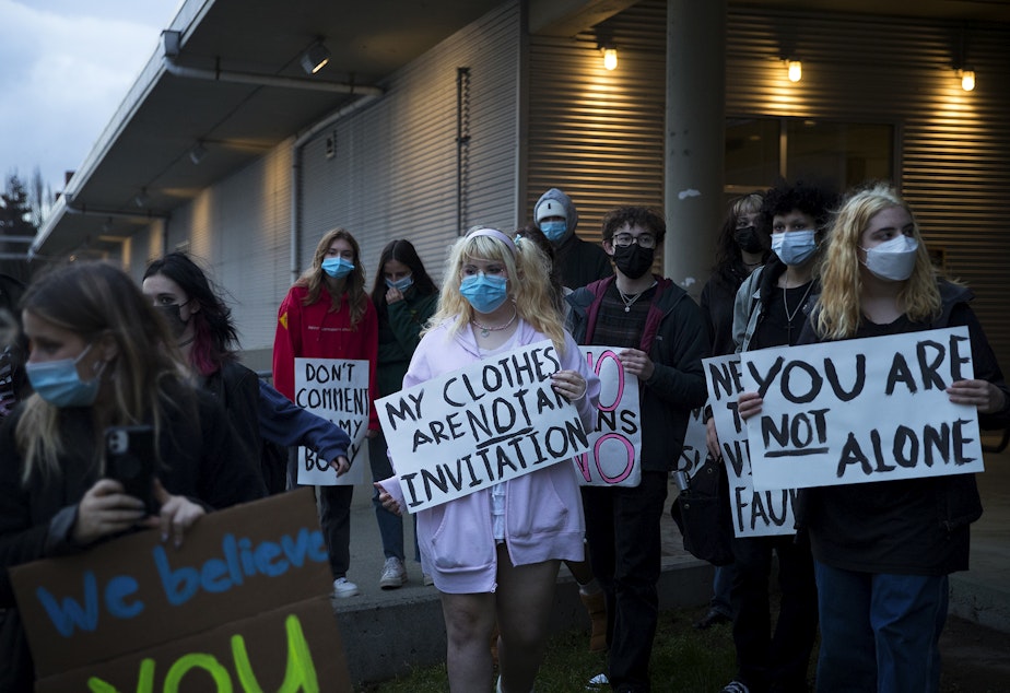 caption: Students from multiple high schools gathered in protest of how cases of sexual assault are handled outside of the  Seattle Public Schools school board meeting on Wednesday, December 1, 2021, along 3rd Avenue South in Seattle. 