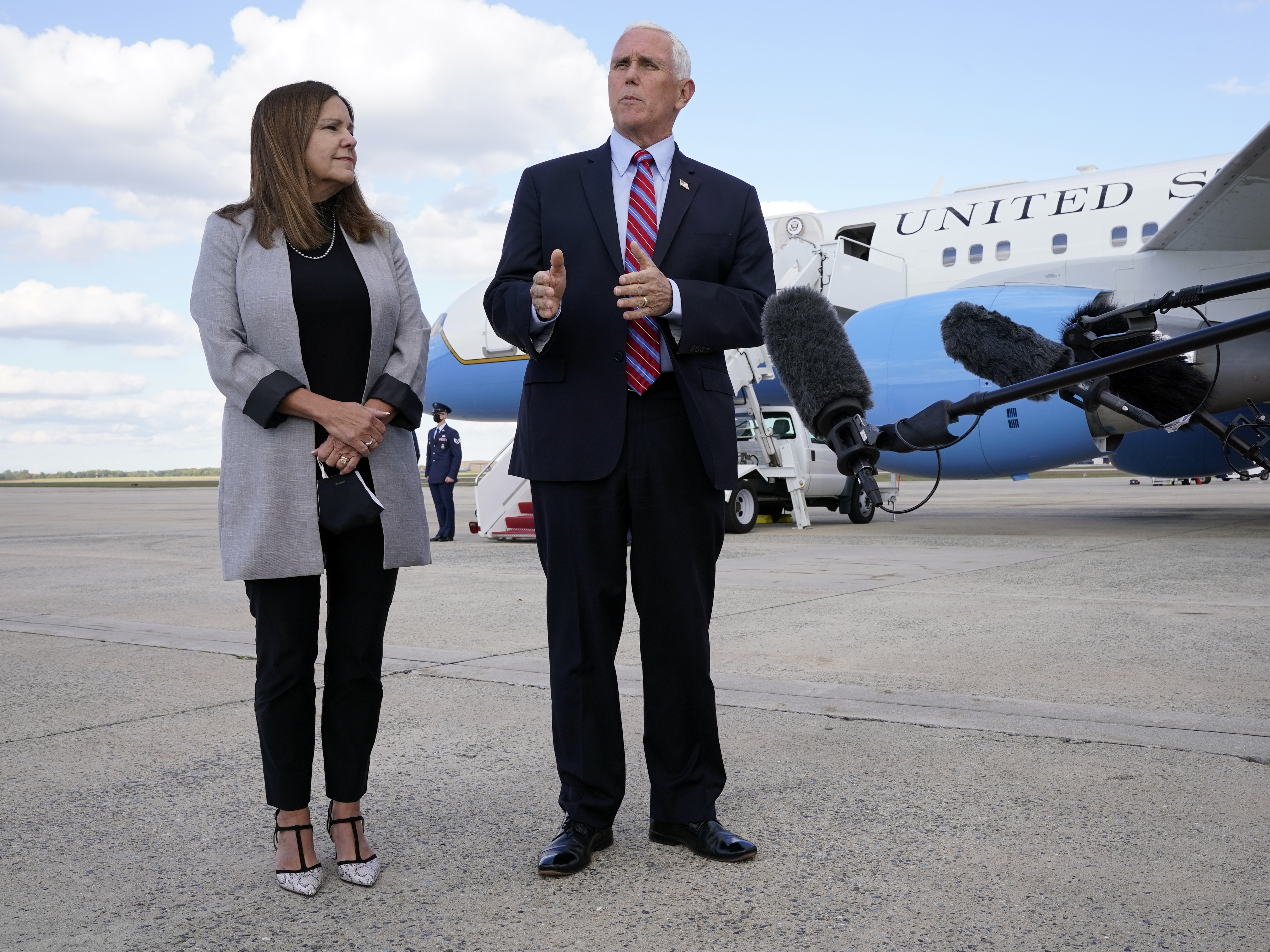 caption: Vice President Pence, pictured with second lady Karen Pence, speaks to reporters at Andrews Air Force Base in Maryland en route to Utah on Monday.