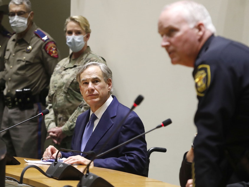 caption: "The protestors have expressed their anger over police misconduct" — and his department will change how it operates, says Fort Worth Police Chief Ed Kraus, far right, seen here earlier this month at a briefing with Texas Gov. Greg Abbott.