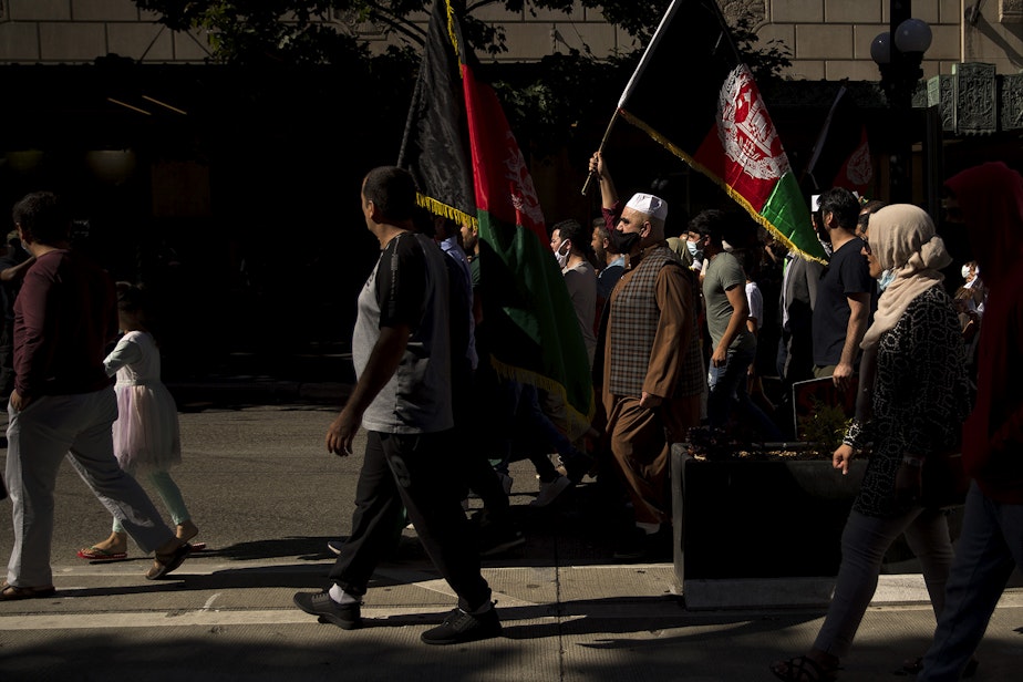 caption: About 100 people attended a rally and march to stand in solidarity with Afghans on Saturday, August 28, 2021, at Westlake Park in Seattle. "What is happening in Afghanistan is devastating," said Shugla Kakar, with Afghans of Seattle. "We're trying to amplify Afghan voices and experiences, and push for urgent action by our federal, state and local leaders to help evacuate those at grave risk in Afghanistan while also supporting the incoming Afghan refugees in our state." 