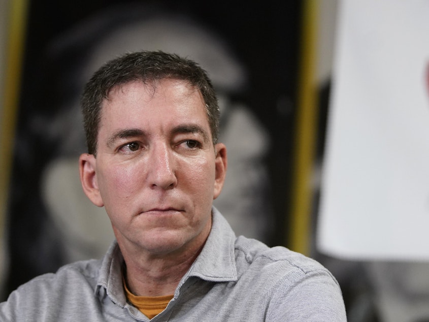 caption: Journalist Glenn Greenwald, shown here during a press conference last July, has been accused by Brazilian federal prosecutors in a hacking probe.