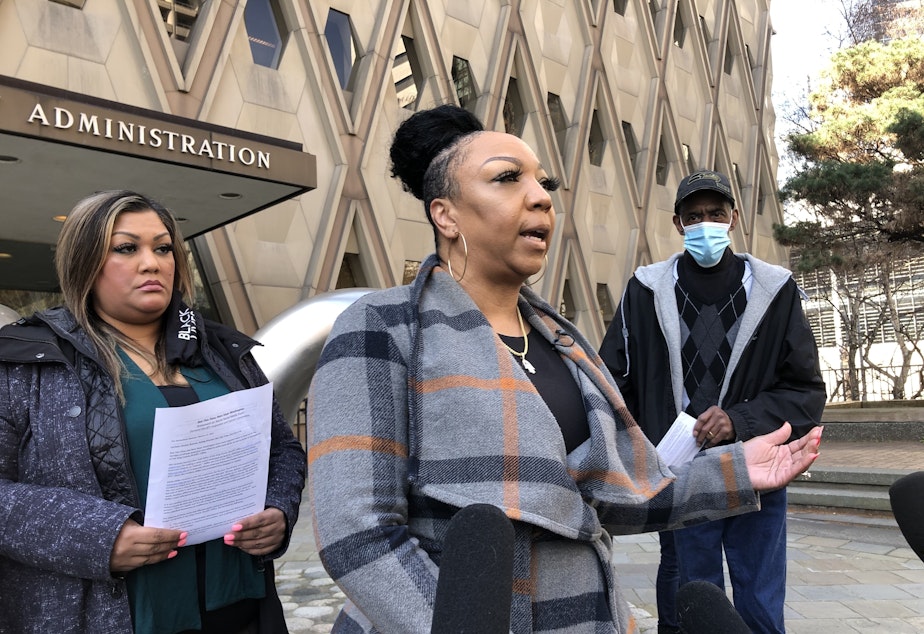 caption: Alexis Francois, center, says KCSO discipline was too lenient for officer who referred to Black youth as "animals" in a Facebook post.