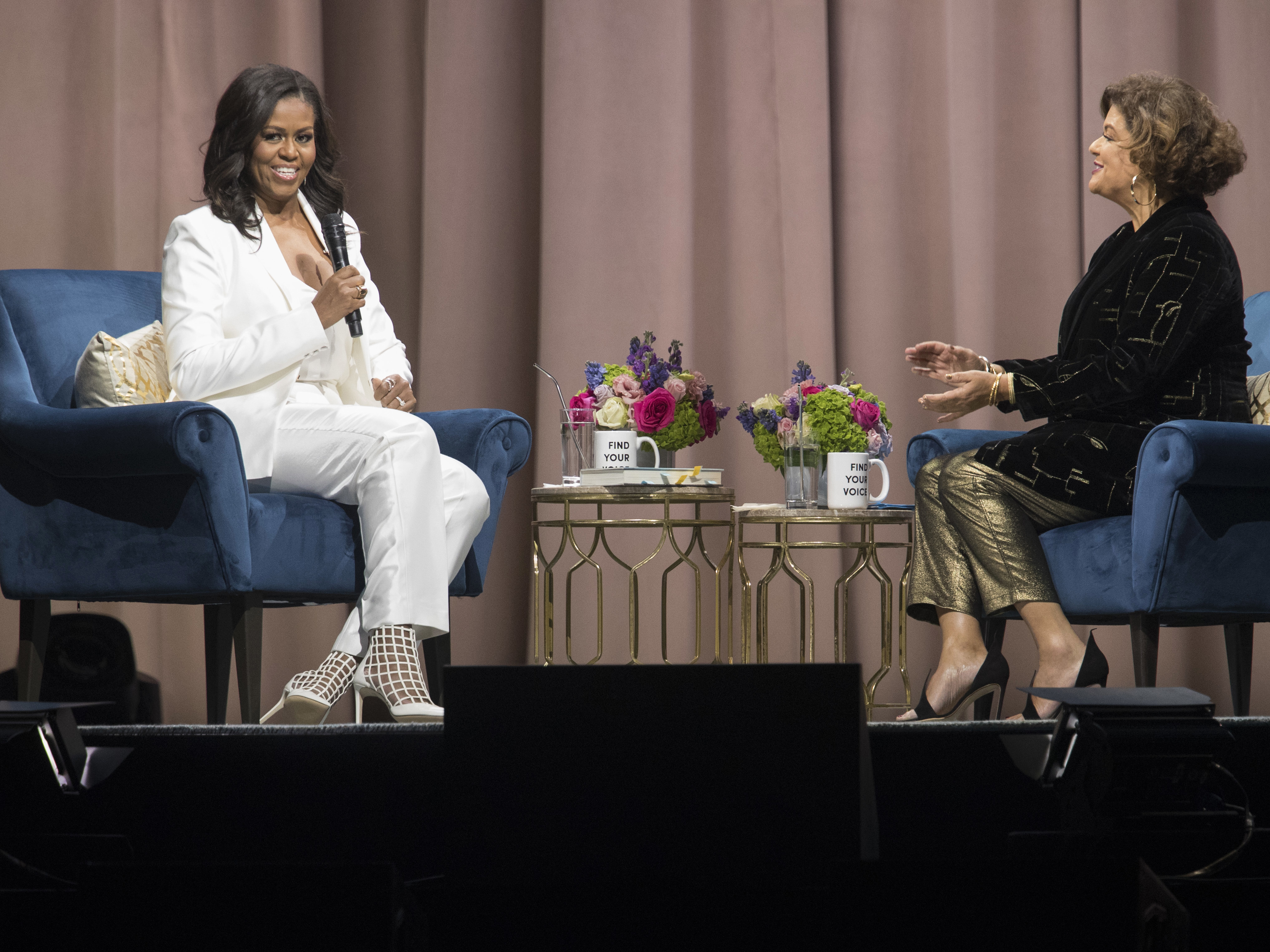 caption: Michelle Obama (left) talks with poet Elizabeth Alexander during an event for the former first lady's memoir at Barclays Center in Brooklyn, N.Y., on Saturday.