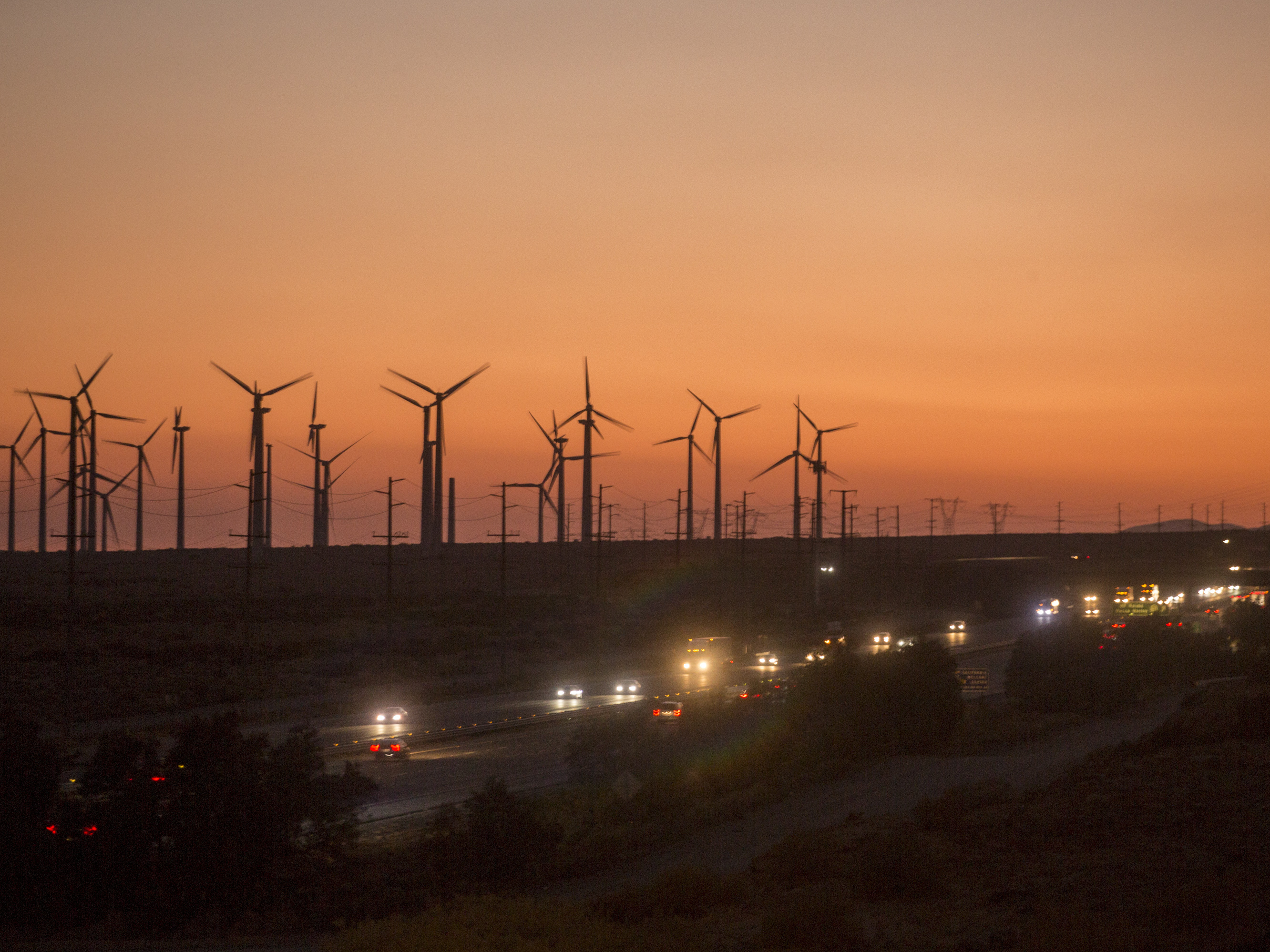 caption: Windmills near Whitewater, Calif., in 2020. Reducing fossil fuel use and investing more in renewable energy sources such as wind will help the U.S. avoid billions of dollars of economic costs and help Americans live longer, healthier lives according to the Fifth National Climate Assessment.