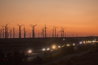 caption: Windmills near Whitewater, Calif., in 2020. Reducing fossil fuel use and investing more in renewable energy sources such as wind will help the U.S. avoid billions of dollars of economic costs and help Americans live longer, healthier lives according to the Fifth National Climate Assessment.