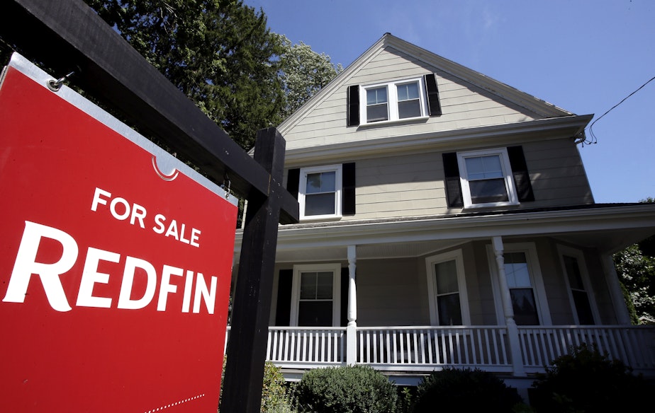 caption: In this July 9, 2018, file photo, a for sale sign stands outside a pre-existing home, in Walpole, Mass.