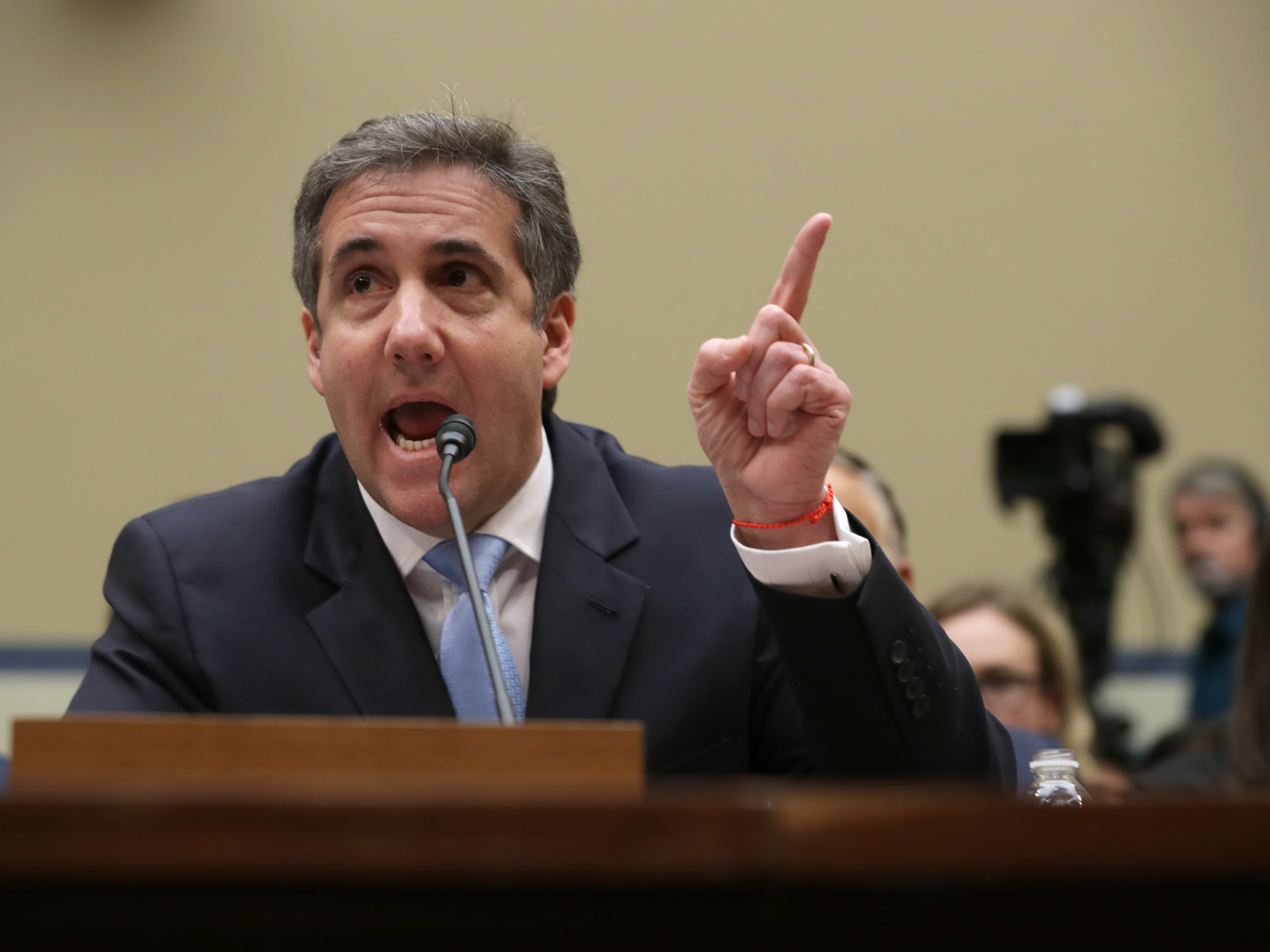 caption: Michael Cohen, former attorney and fixer for President Trump, testifies before the House Oversight Committee on Wednesday.