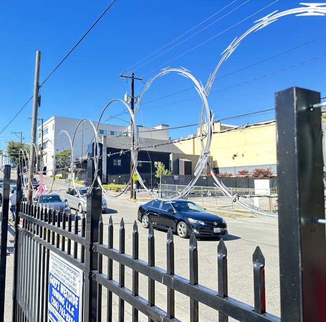caption: Lam's Seafood Asian Market near Summit Sierra High School recently installed an intimidating barbed wire fence to keep crime out.