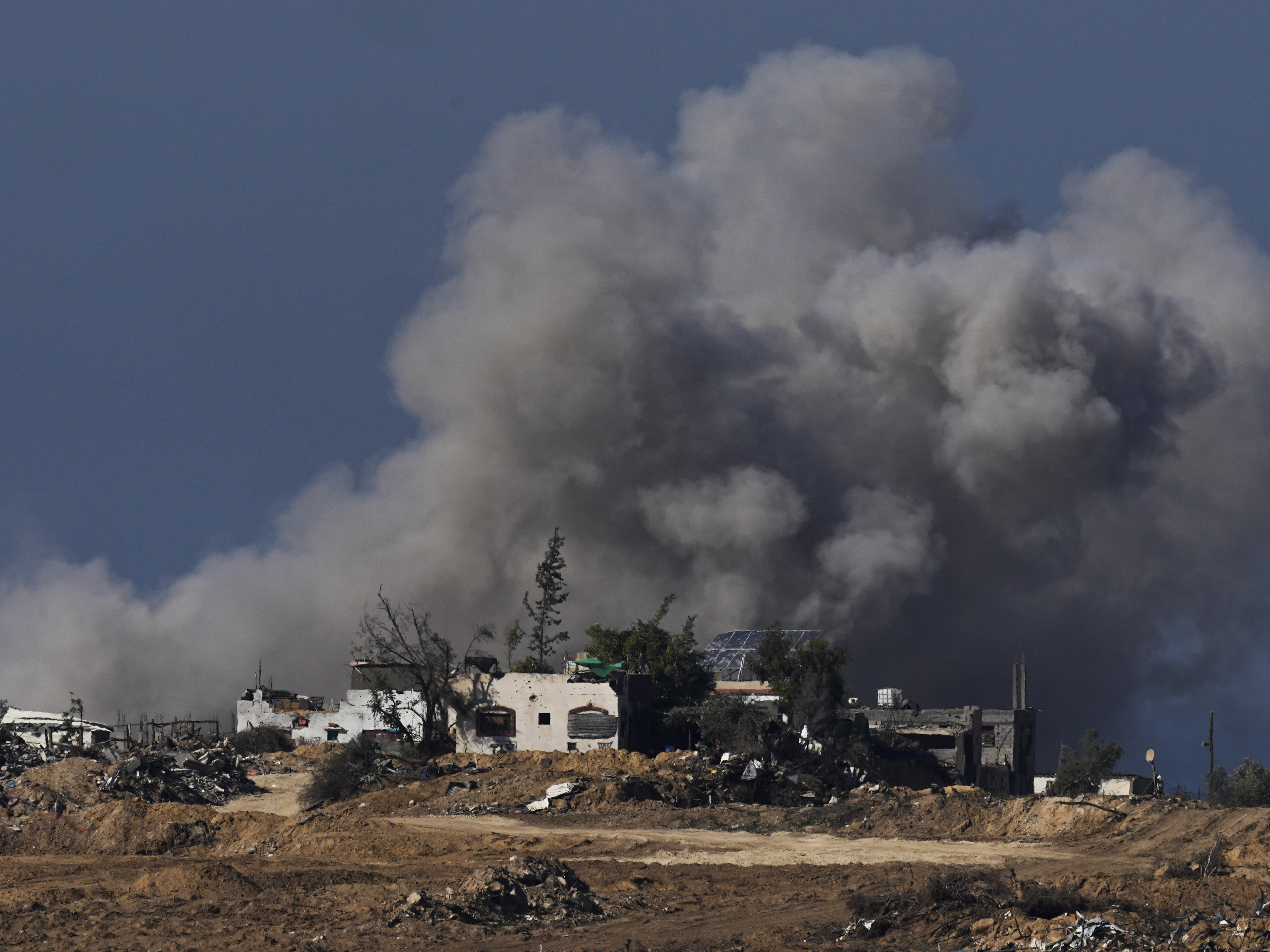 caption: Smoke rises following an Israeli bombardment in the Gaza Strip, as seen from southern Israel, on Sunday.