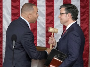 caption: House Minority Leader Hakeem Jeffries of N.Y., hands the gavel to newly elected House Speaker Mike Johnson of Louisiana at the Capitol on Wednesday.
