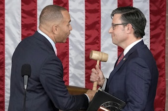 caption: House Minority Leader Hakeem Jeffries of N.Y., hands the gavel to newly elected House Speaker Mike Johnson of Louisiana at the Capitol on Wednesday.