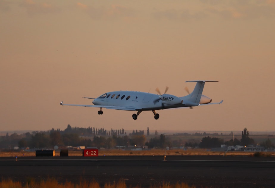 caption: The all-electric Eviation Alice commuter plane took off on its maiden flight at sunrise Tuesday from Grant County International Airport in Moses Lake, Washington.