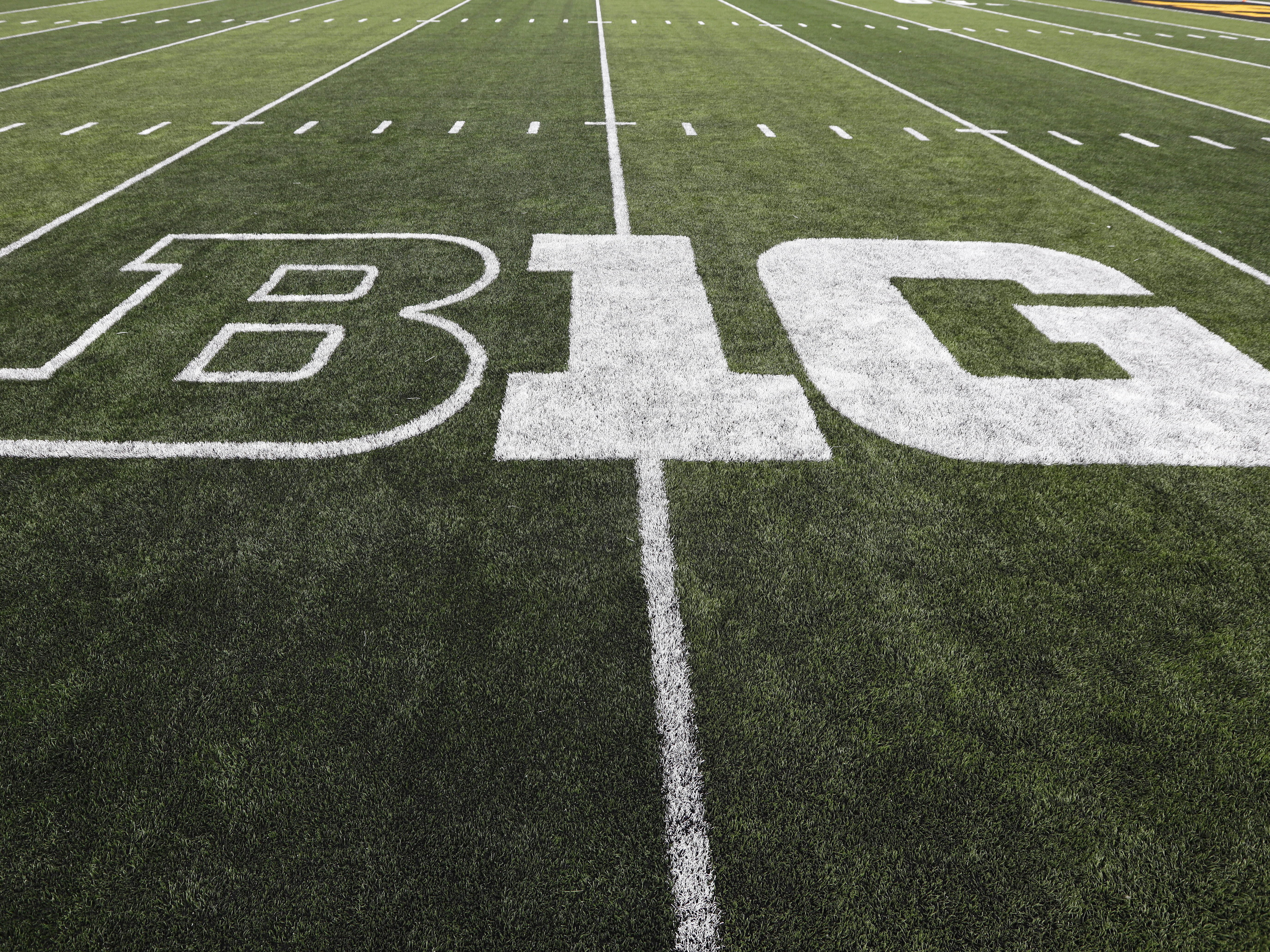 caption: The Big Ten, one of the so-called "Power 5" NCAA conferences, is postponing fall sports because of the coronavirus. The conference logo is displayed on the field before a football game between Iowa and Miami of Ohio in Iowa City, Iowa.