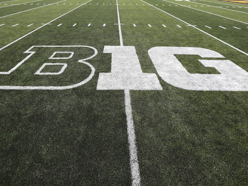 caption: The Big Ten, one of the so-called "Power 5" NCAA conferences, is postponing fall sports because of the coronavirus. The conference logo is displayed on the field before a football game between Iowa and Miami of Ohio in Iowa City, Iowa.