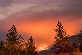 caption: Wildfire burns above the Fraser River Valley near Lytton, British Columbia, Canada, on Friday.