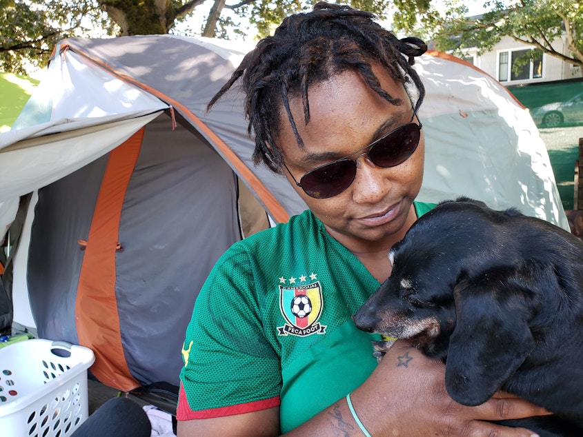 caption: Brooklyn Gardenshire and her dog, Taz,  at the Tent City 3 camp beside I-5 in Ravenna on Tuesday, August 27, 2019. Gardenshire has moved five times in the 10 months she's lived with Tent City 3. On September 7, she'll move again with the camp to a church in Tukwila. 