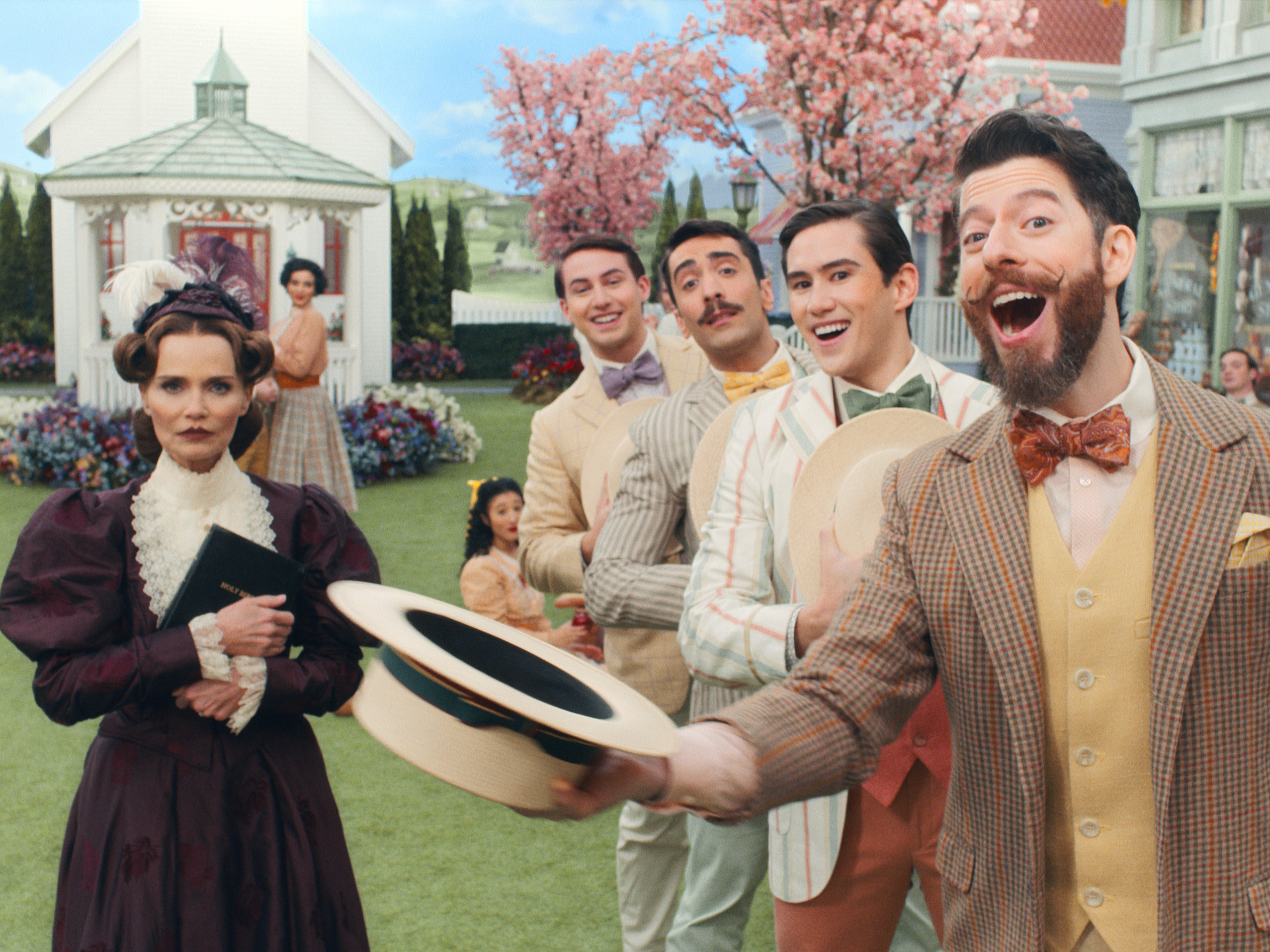 caption: Kristin Chenoweth and the company of <em>Schmigadoon!</em>, premiering July 16 on Apple TV+.