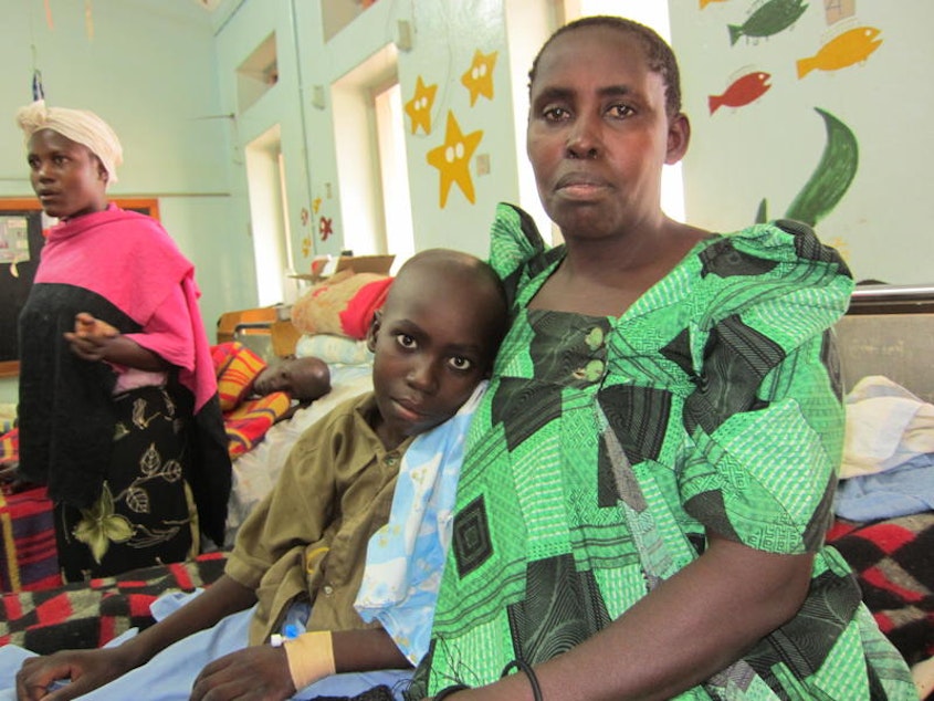 caption: Mother and son in the children's ward at Uganda Cancer Institute in Kampala.