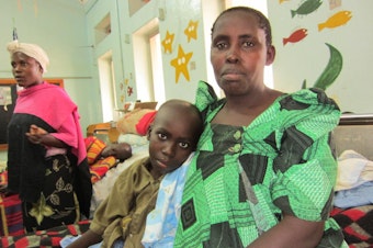 caption: Mother and son in the children's ward at Uganda Cancer Institute in Kampala.