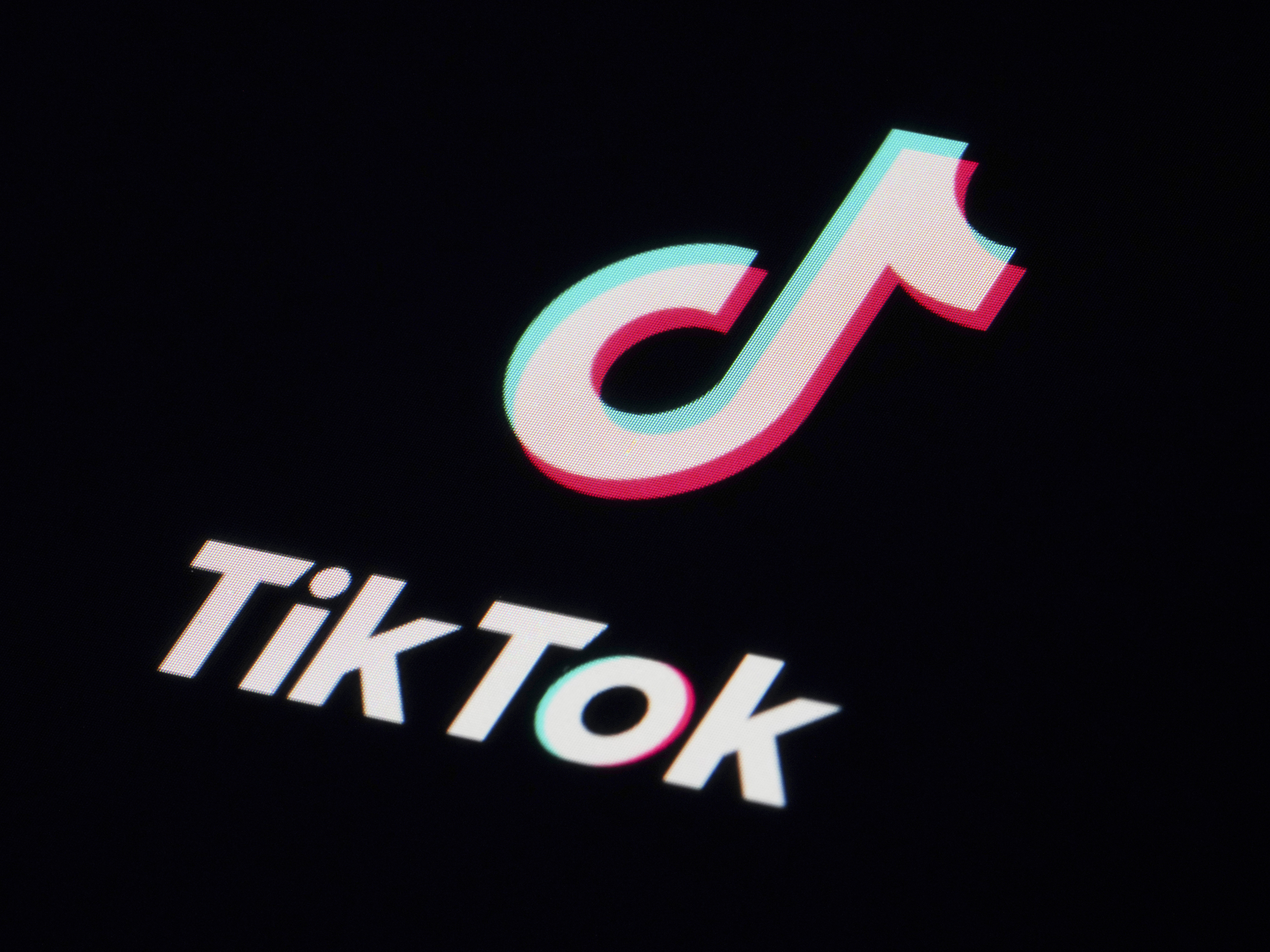 caption: The icon for the TikTok video sharing app is seen on a smartphone in Marple Township, Pa., Feb. 28, 2023.