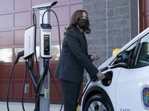 caption: Vice President Harris charges an electric vehicle during a tour of the Brandywine Maintenance Facility in Prince George's County, Md. There, she highlighted electric vehicle investments.