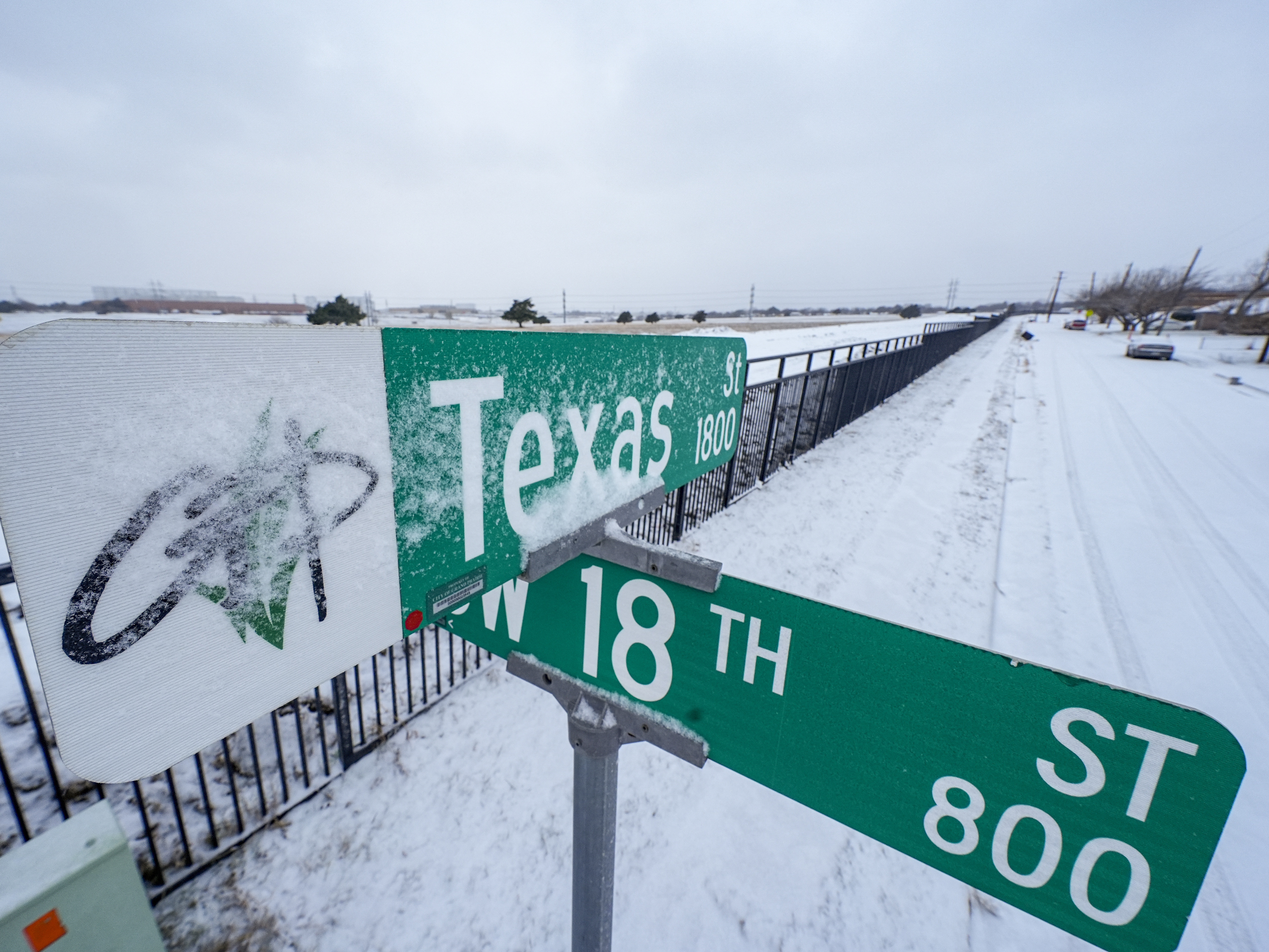 caption: Snow covers the sign for Texas Street during a winter storm that hit Grand Prairie, Texas, in 2024. Some parts of Texas are preparing to be hit with several inches of snow this month.