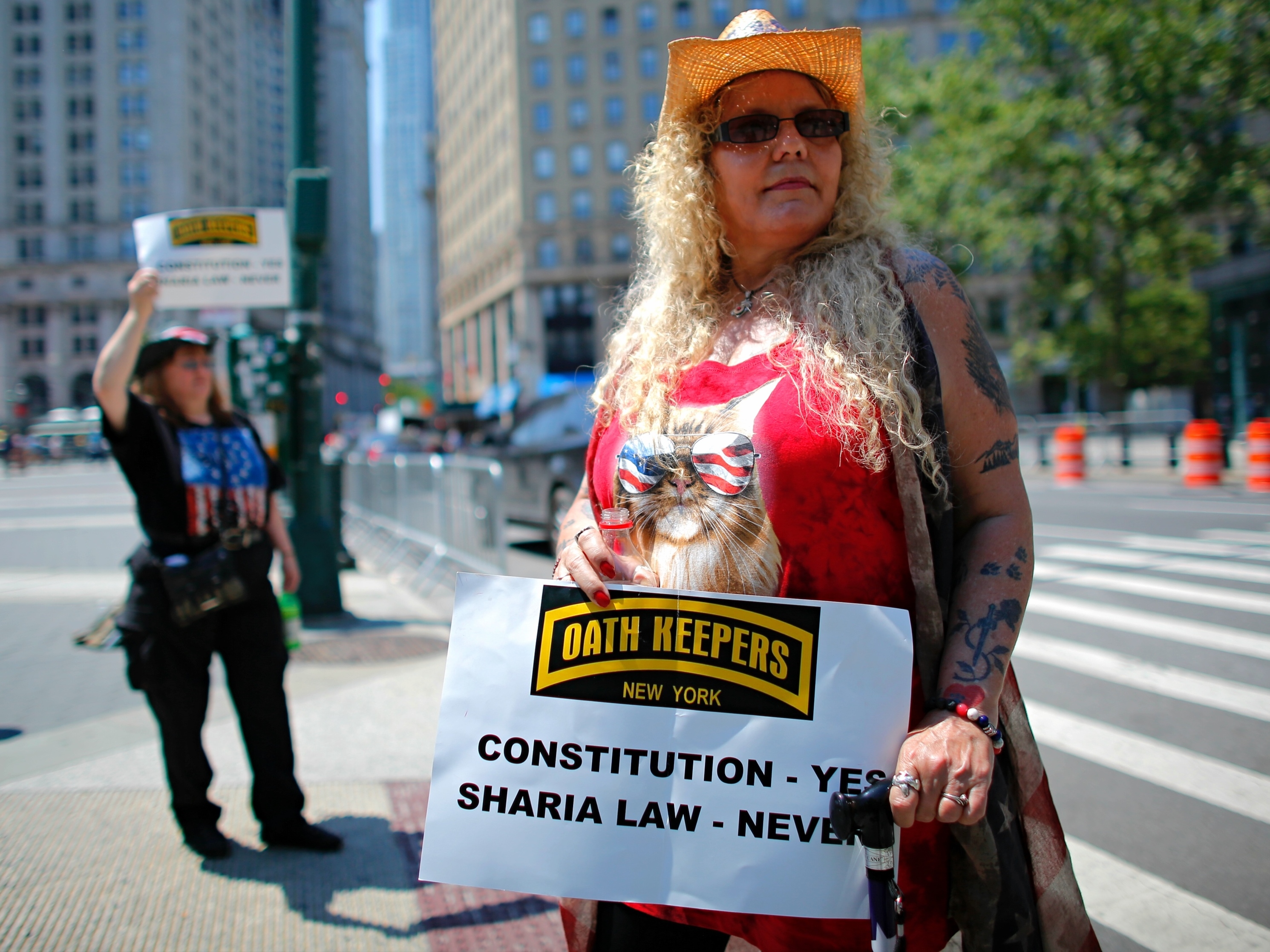 caption: A Trump supporter holds up a sign during an anti-Sharia law rally organized by ACT for America. A new report finds that mainstream philanthropies are unknowingly funneling donations to anti-Muslim groups such as ACT for America.