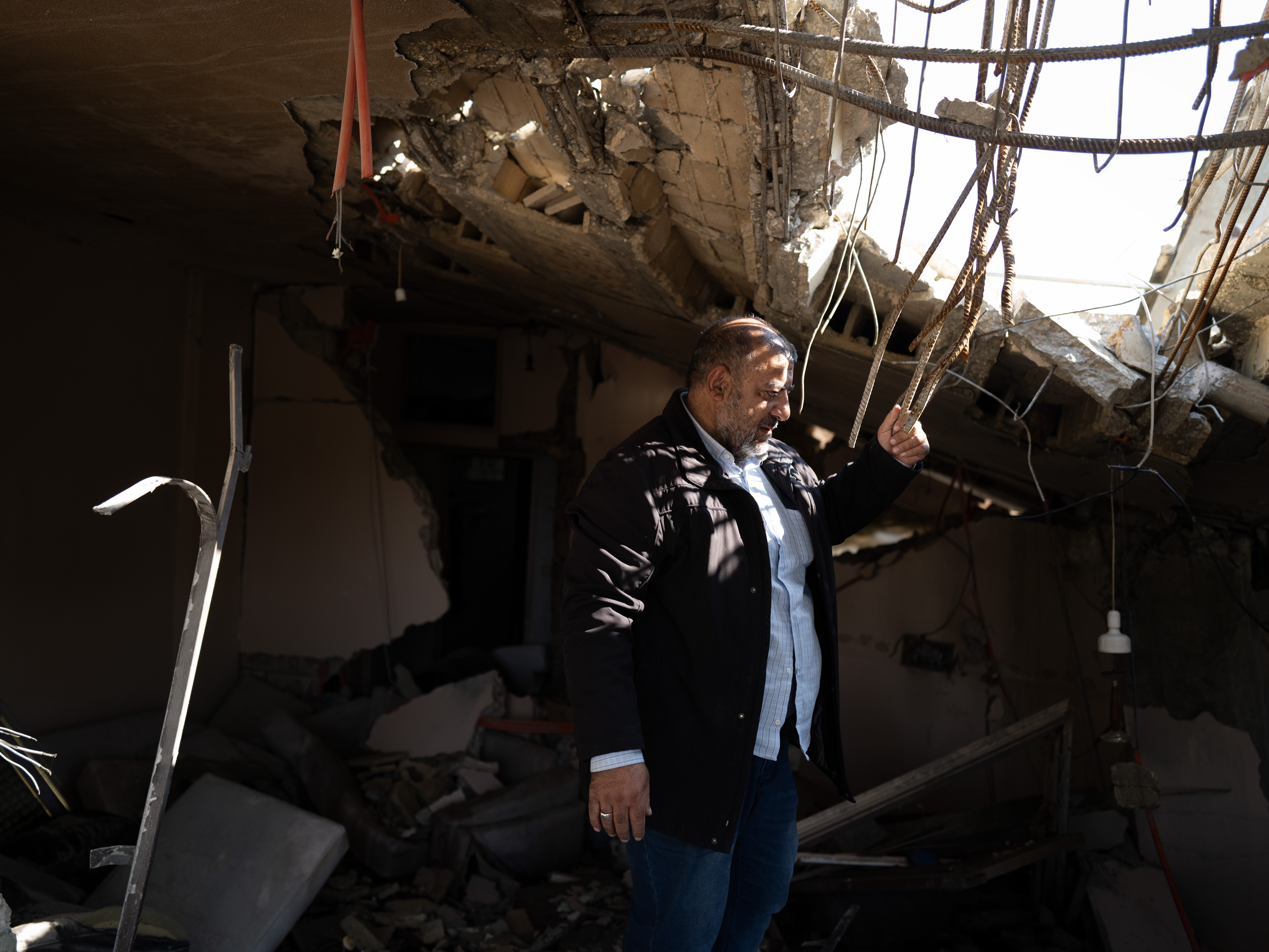 caption: Khalil Moussa Shoumar, 55, stands in the rubble of his home. Shoumar is an auto parts seller whose house in Nabatieh was destroyed by Israeli airstrikes twice, first in 2006 and again in October.