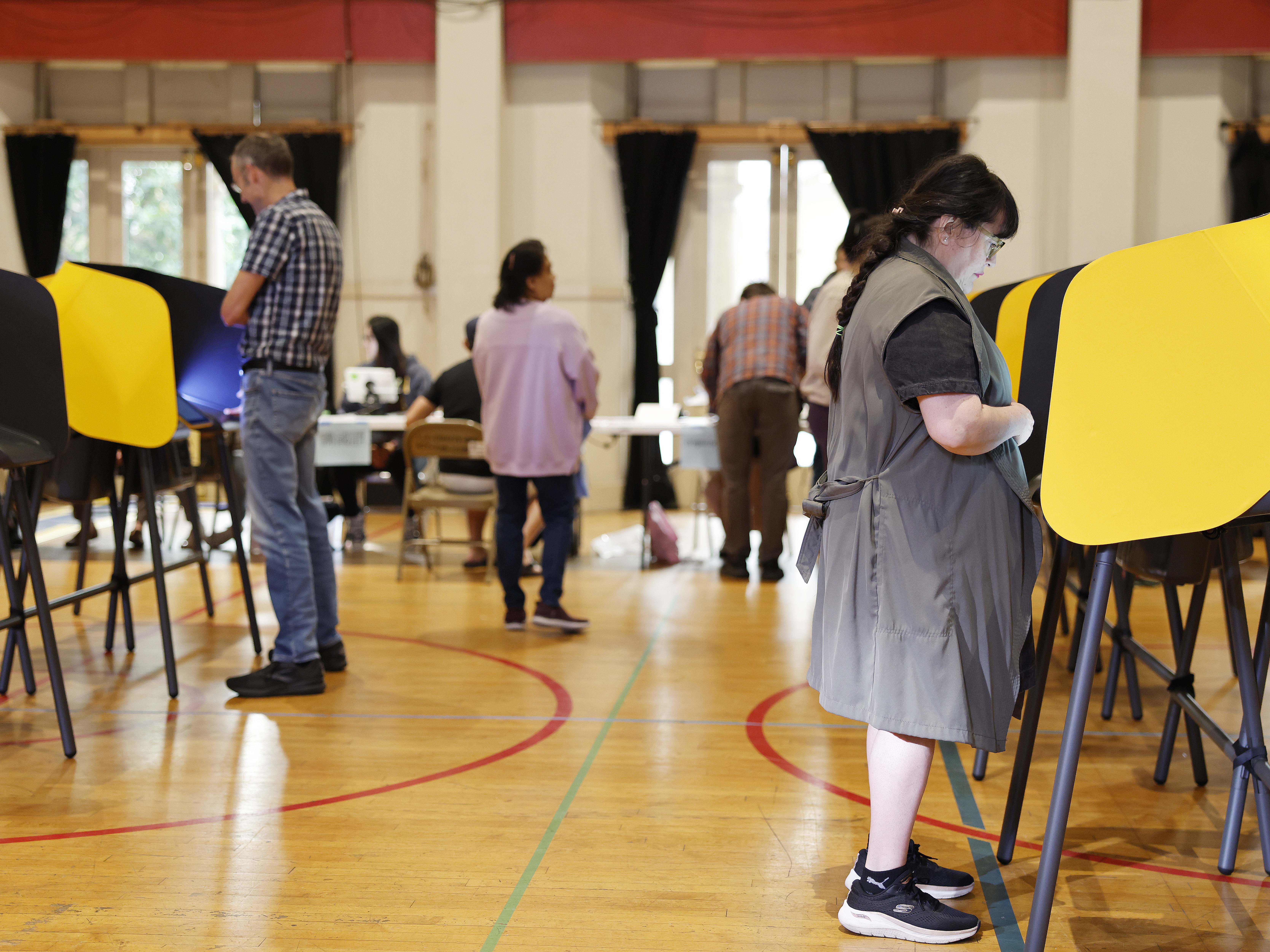 caption: People vote at a polling station in Pasadena, Calif., on Nov. 4, 2025.