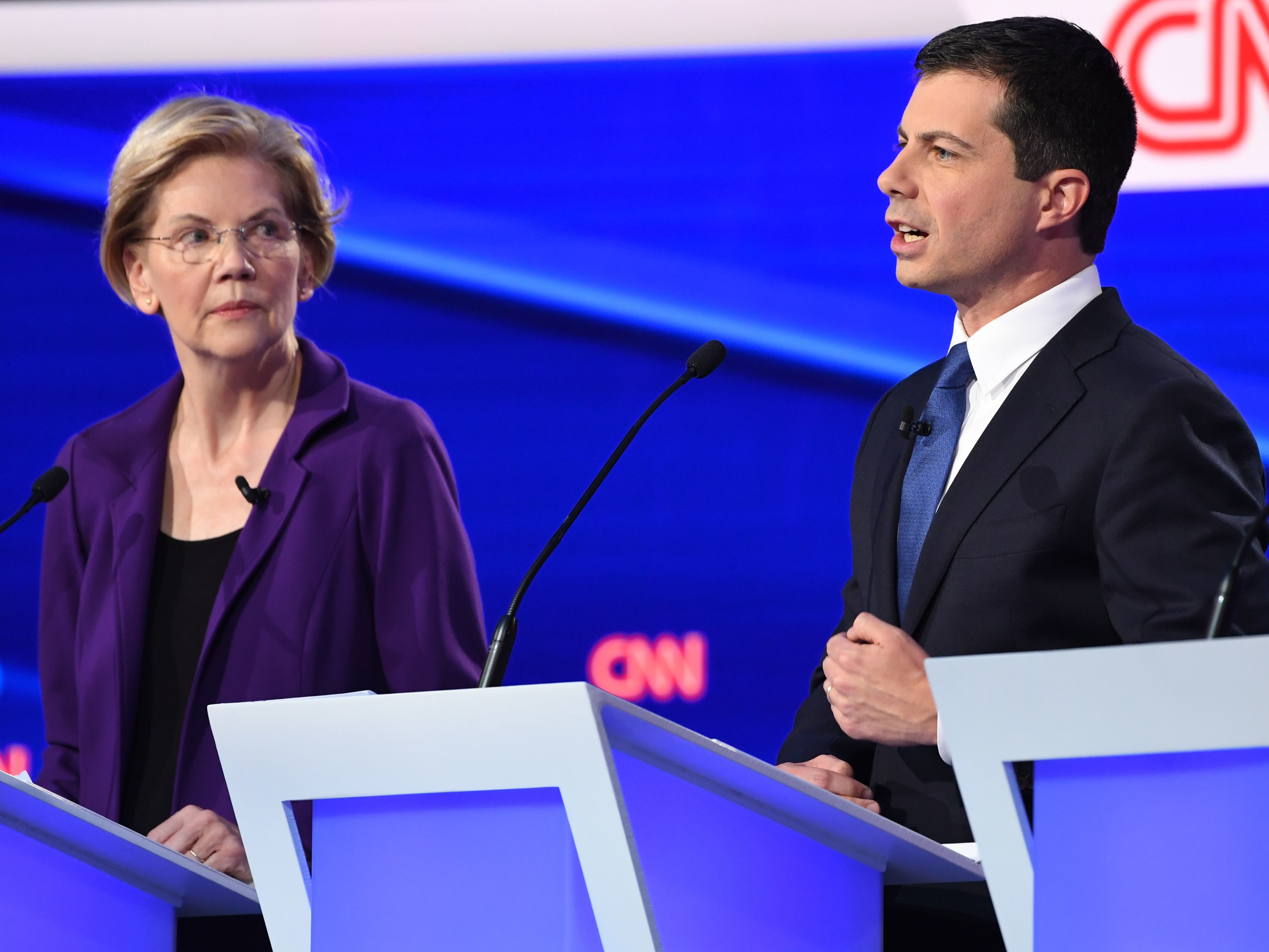 caption: Massachusetts Sen. Elizabeth Warren looks on as South Bend, Ind., Mayor Pete Buttigieg speaks during Tuesday's Democratic presidential debate. Warren's policy positions were described as unrealistic and expensive by her rivals in the Democratic debate.