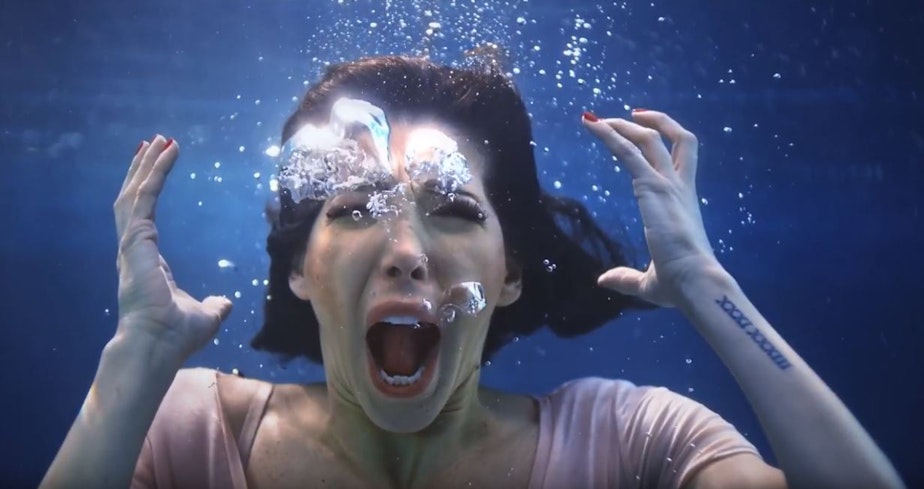 caption: Screenshot from the music video for the song 'Leave Them' features childhood sexual assault survivors scream underwater as a way to highlight their silence. 