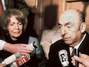 caption: Chilean writer, poet and diplomat Pablo Neruda answers journalists' questions in 1971.