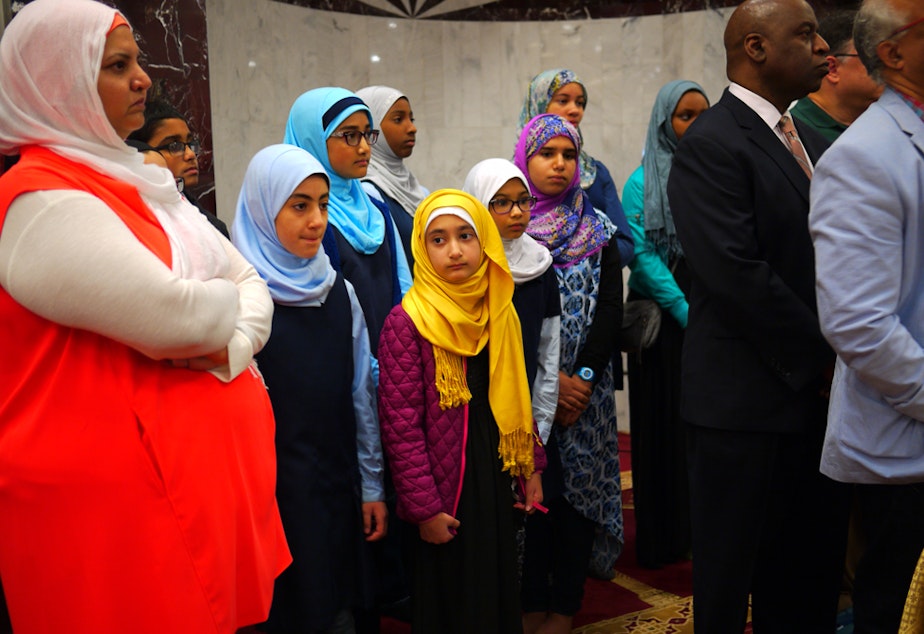 caption: Middle school students at the Muslim Association of Puget Sound attend a press conference concerning a recent threat following the Orlando shooting.